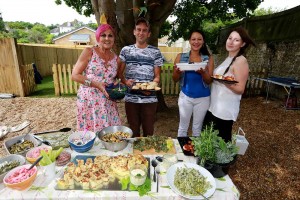 Residents celebrating in the new garden with food grown in it